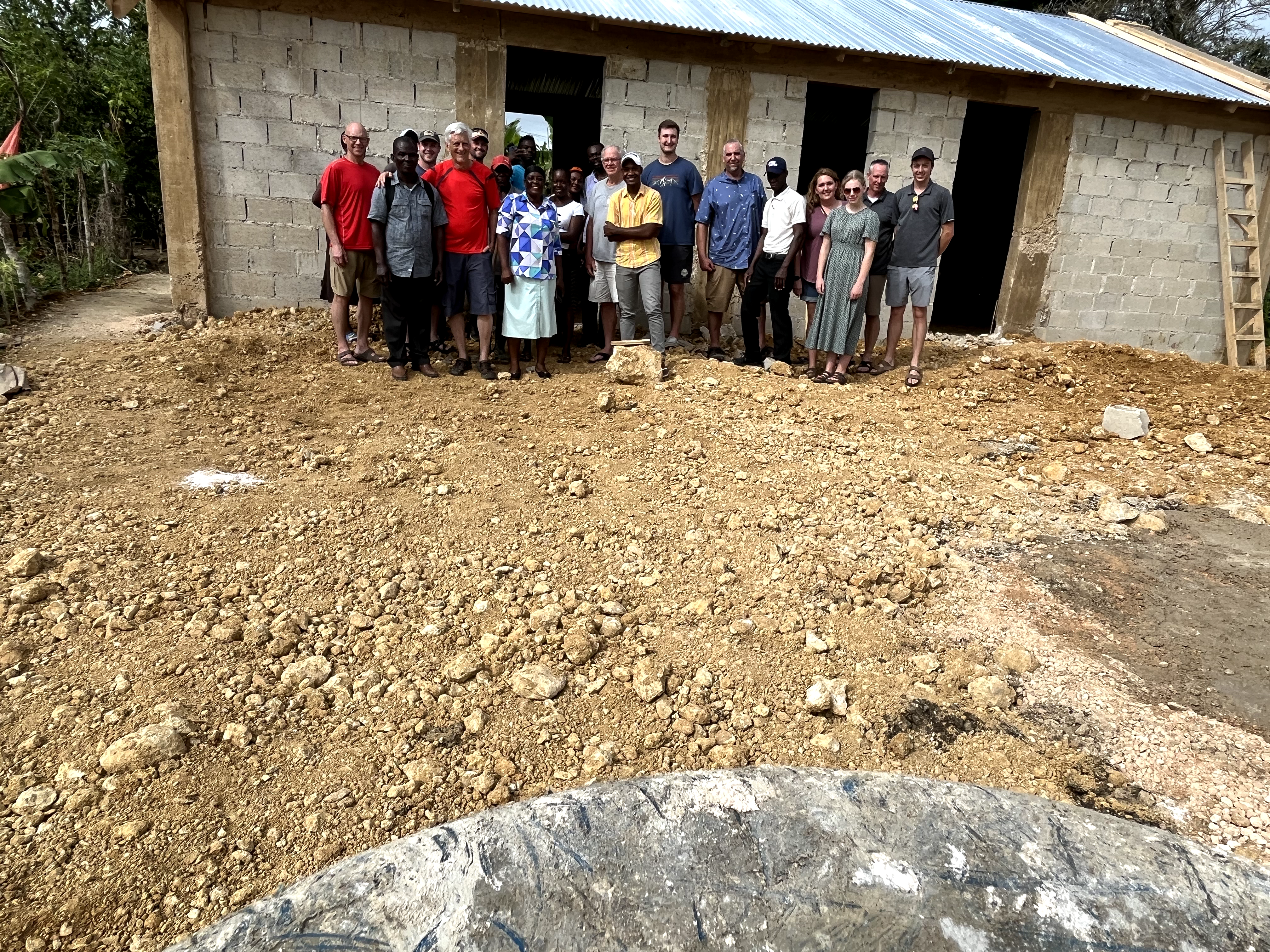 A CRC church from the United states and a church in the Dominican Republic stand in front of the new church building they constructed