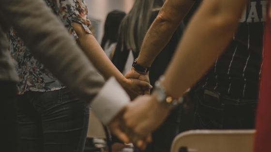 people in church holding hands