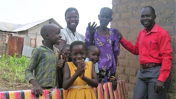 A family stand with a neighbor and her new mattress