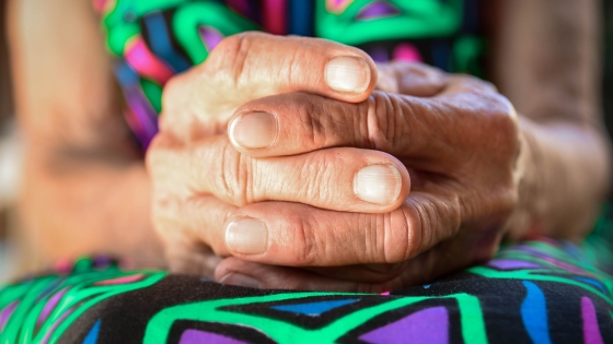 Hands folded in lap in prayer