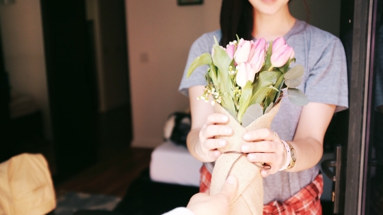 Handing flowers to a neighbor