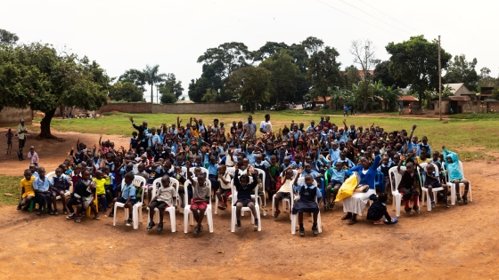 Children sit in a schoolyard