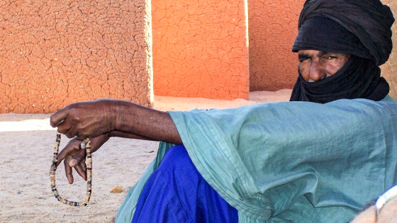 A man sits against a wall