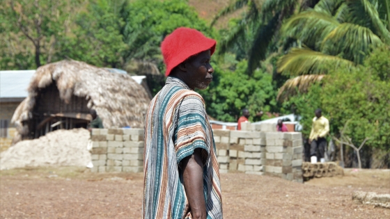 A man stands in a village