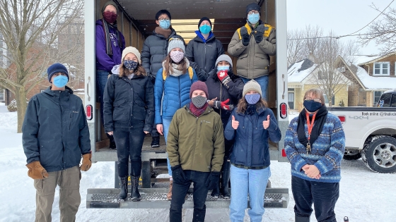 Students unload food from a truck