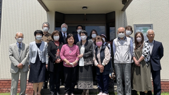 Yamato and his church stand outside their church building