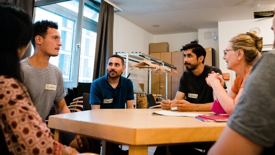 People gather around a table for the Language Cafe