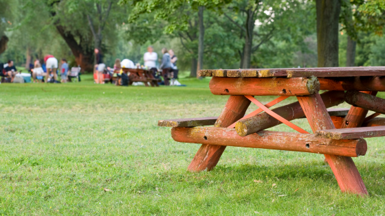 Picnic table with group of people in the background