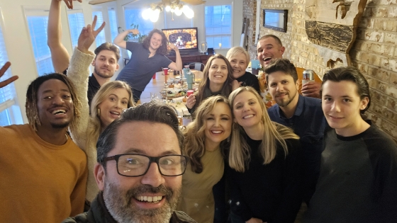 Phil covert takes a selfie with a group of artists