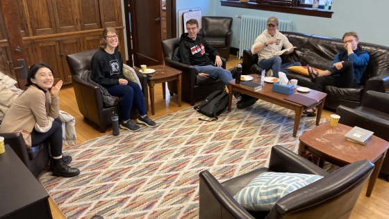 A group of students gather in cozy chairs for Theology Breakfast