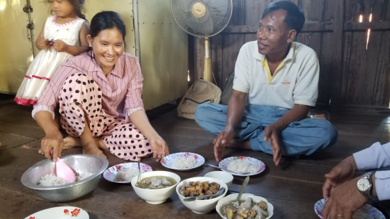 Pastor Sophon and Mrs. Chan Thach smile while sharing a meal