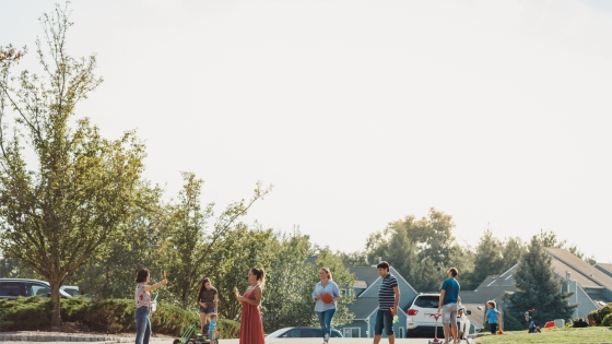 Neighbors gathering together in a street in a quiet neighborhood
