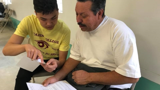 A Calvin College Student Testing the vision of a clinic participant