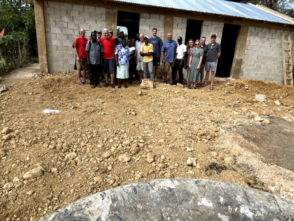 Volunteers from Faith CRC and the local community in the Dominican Republic by the brand new church building