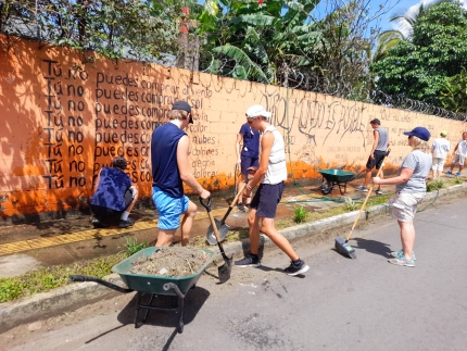 Students cleaning up and working on landscaping