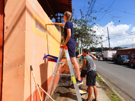 Students painting a wall