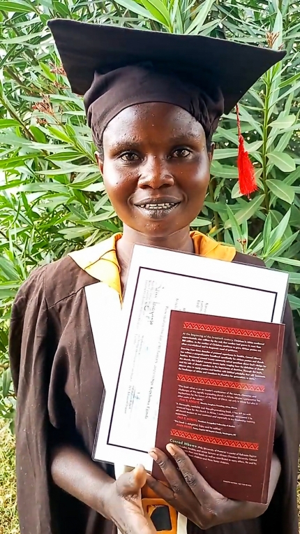 Muduwa Rose in her cap and gown after graduating from the TLT program