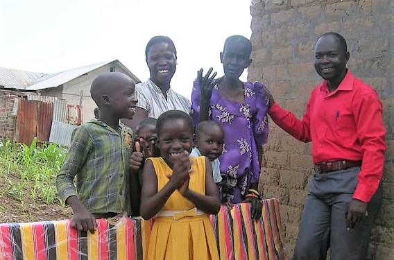 A family stand with a neighbor and her new mattress