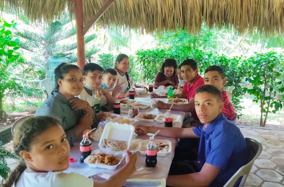 Patricia and other members of IMPACT enjoy dinner together