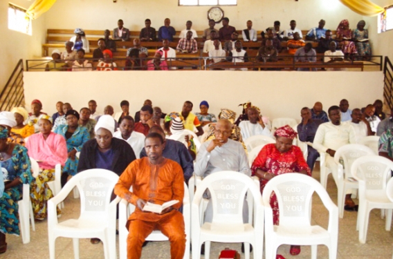Discipleship Manual Teaching Believers gather in church to work through a discipleship manual