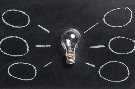 Innovation Lightbulb with thought bubbles
