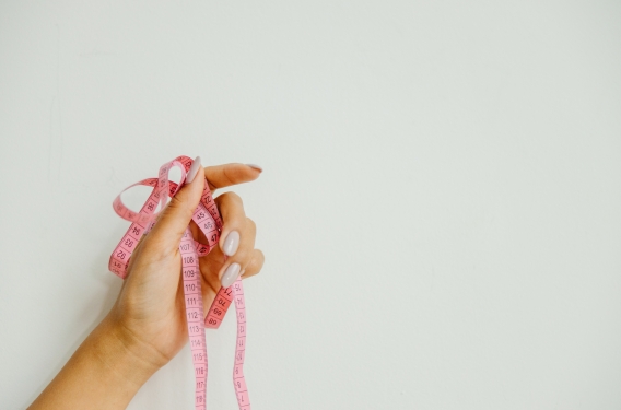 Missional Metrics A hand holding a measuring tape