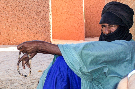 A man sits against a wall