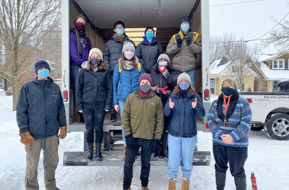 Students unload food from a truck