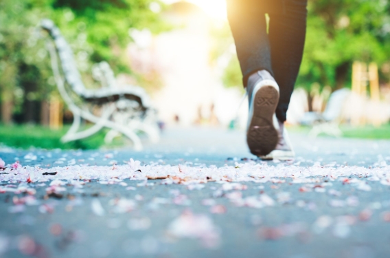 Feet of someone walking on a park path