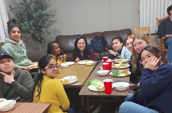 Medicine Hat College Campus Ministry A group of students gather around a table for food