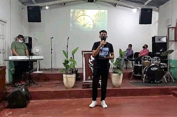 Luis from IMPACT Luis speaks in front of church