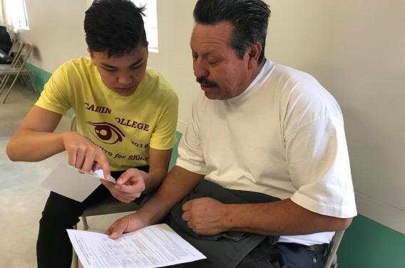 A Calvin College Student Testing the vision of a clinic participant